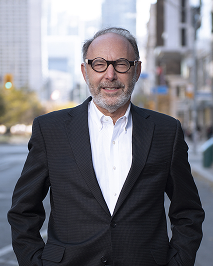 Leonard Finegold smiling in a suit