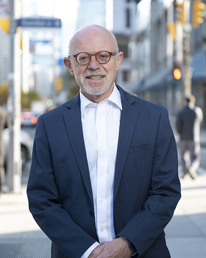 Ernest F. Gutstein smiling in a suit