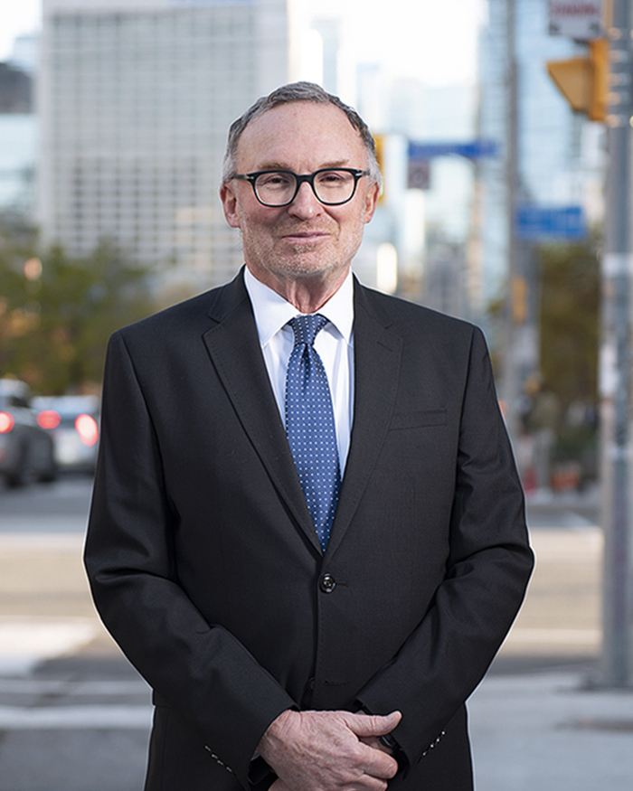 Robert D. Malen smiling in a suit