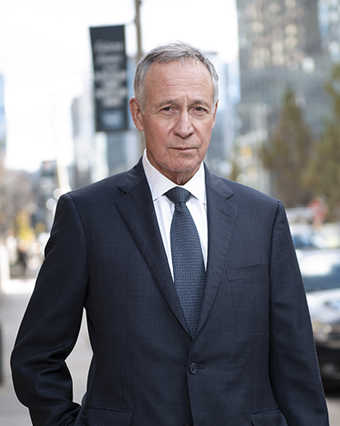 John McKeown smiling in a suit