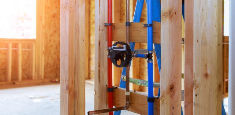 coloured plumbing on a wooden wall