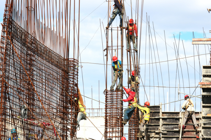 construction workers working on iron beams