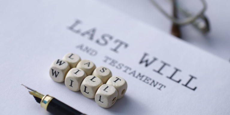 wooden cubes that read "last will" on a paper that reads "last will and testament"