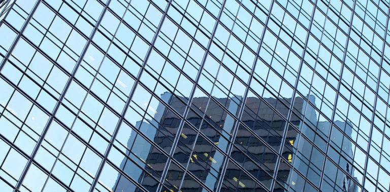reflection of building in skyscraper windows